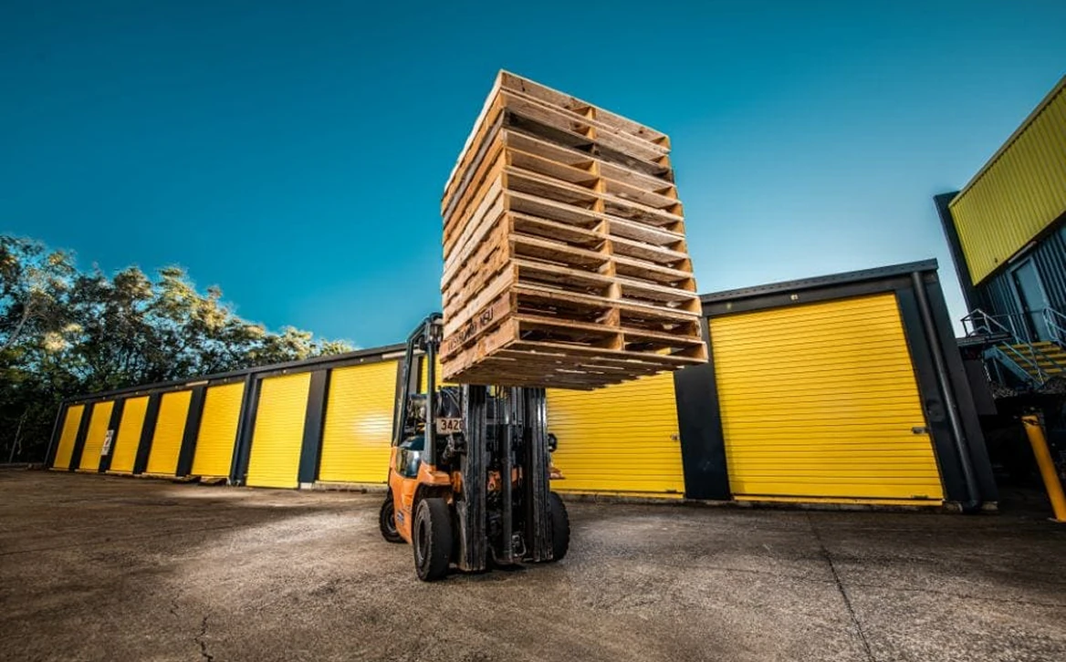 Forklift lifting pallets of stock at a Storage Choice self-storage facility
