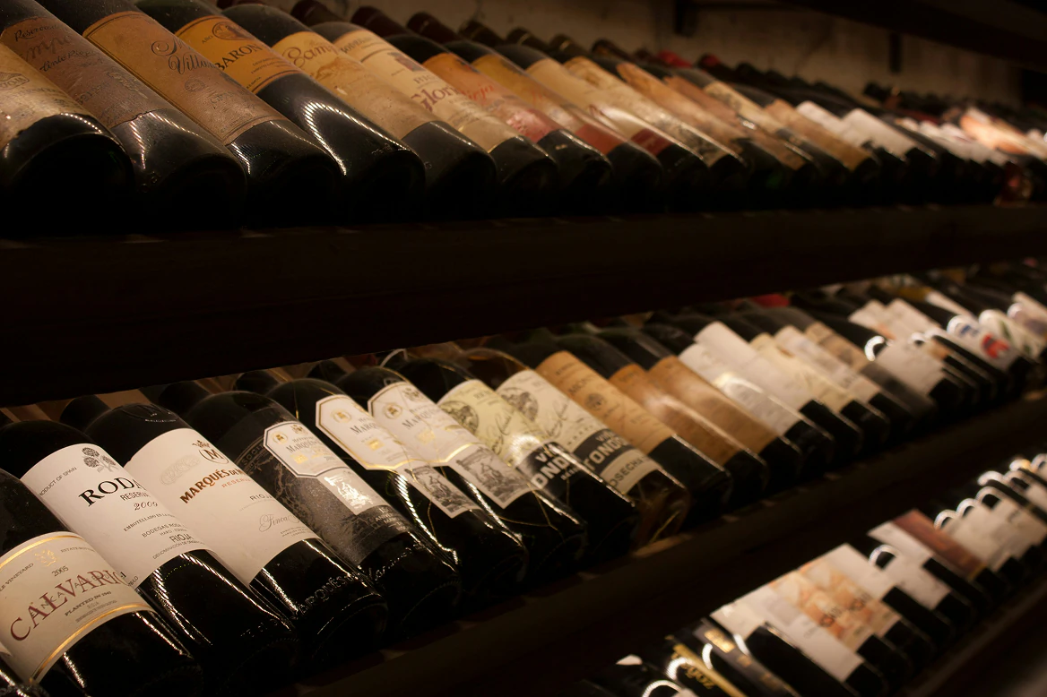 Close-up of wine bottles resting in a temperature-controlled storage rack